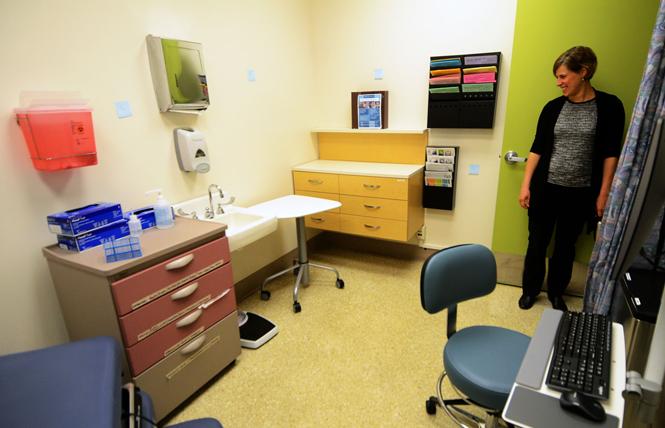 Dr. Stephanie Cohen, medical director at San Francisco's City Clinic, looks into one of the renovated exam rooms during a tour Tuesday, March 19. Photo: Rick Gerharter