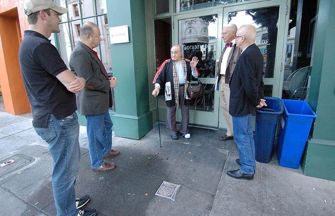 Standing in front of the site of the old Black Cat bar in San Francisco in October 2007, José Julio Sarria, center, reminisced about his time at the bar with, from left, an unidentified man, Don Berger, John Newmeyer, and then-reigning Emperor Michael Dumont. The occasion was the installation of a plaque, foreground, honoring the significance of the bar to San Francisco's LGBT history. Photo: Rick Gerharter