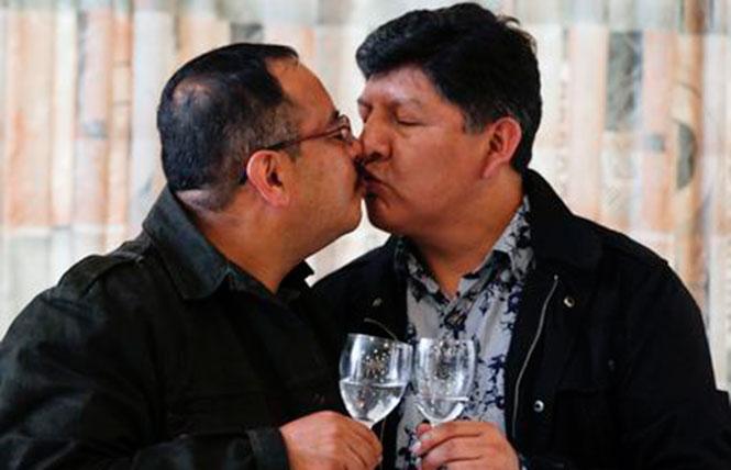 Guido Montano, left, and his partner, David Aruquipa, kissed during a news conference in La Paz, Bolivia, on December 11. Photo: Juan Karita/AP