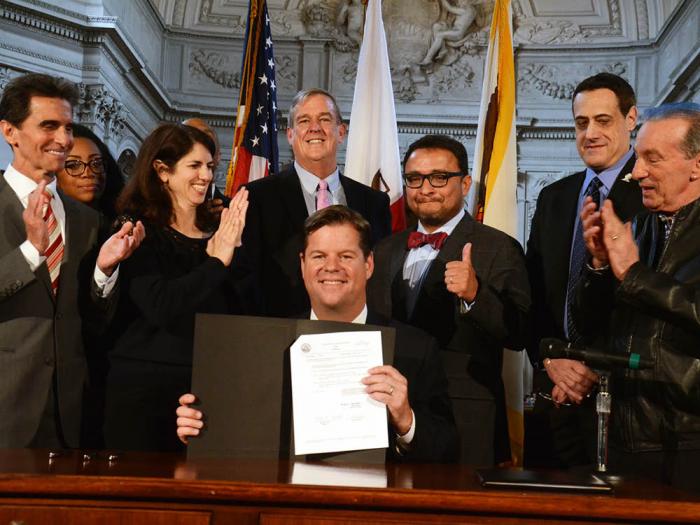 Surrounded by LGBTQ elected officials and supporters, Mayor Mark Farrell signed legislation April 16, 2018 to rename Terminal 1 at the San Francisco International Airport after slain gay supervisor Harvey Milk. Joining Farrell, were, from left, former state senator Mark Leno (D-San Francisco); then-supervisor Malia Cohen; District 9 Supervisor Hillary Ronen; then-District 8 supervisor Jeff Sheehy; former supervisor David Campos; Milk's nephew, Stuart Milk; and former supervisor and assemblymember Tom Ammiano. Photo: Rick Gerharter